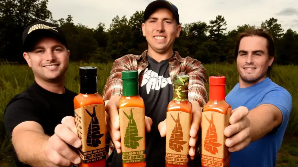 Three Flagler College grads show their sauce, which they learned to market.