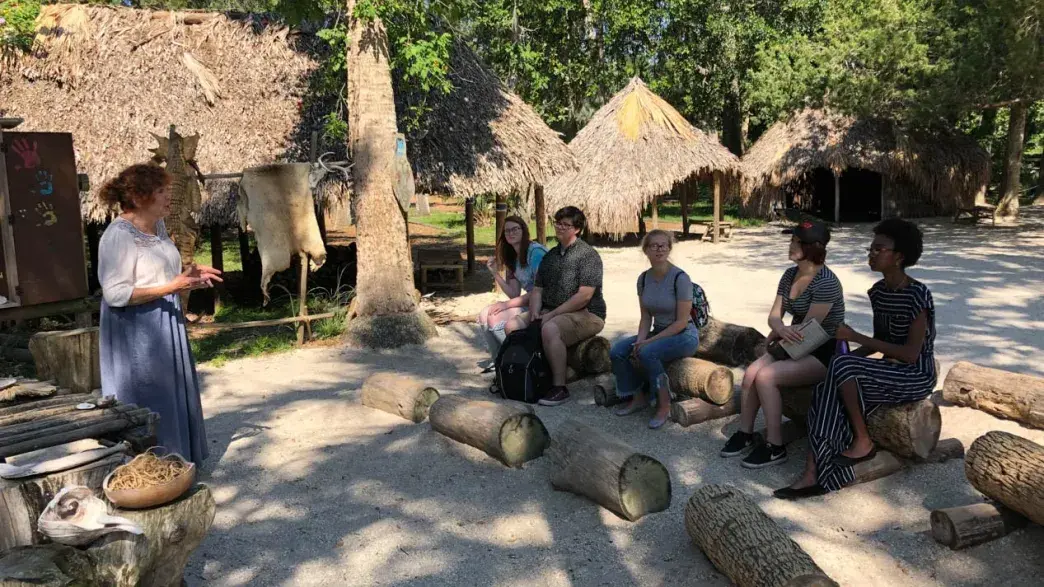 A Flagler College faculty member teaches a class outdoors.