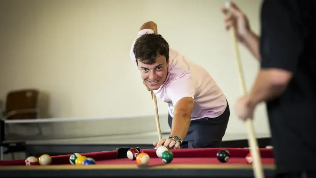 Student playing pool in the Ringhaver Student Center