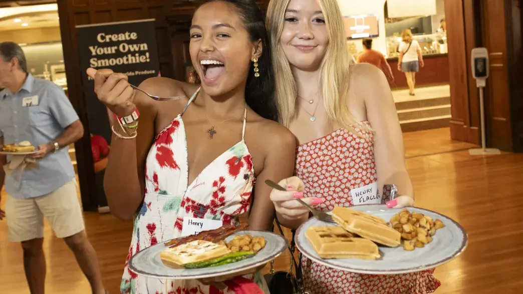 Students eating and posing for the camera.