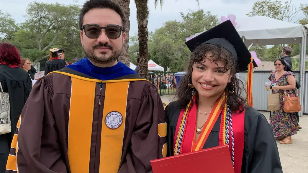 Photo of professor with student at graduation