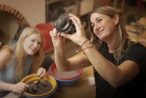Two Flagler College archaeology students look at pottery.