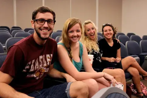 Four Flagler College students smile for the camera.