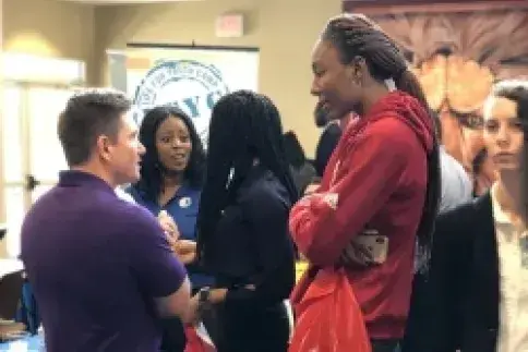 Student chatting with employer