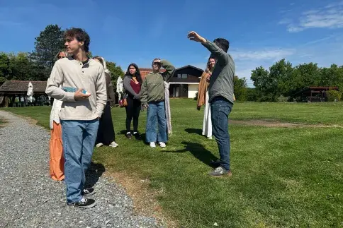 Students and teacher standing on field