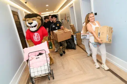 Lewis the Lion and students on move-in day