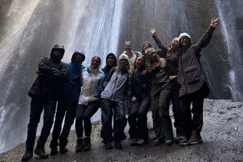 Students in front of waterfall