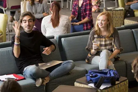 Students seated on couches in the Abare Hall commons