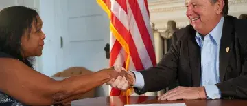 Flagler College President John Delaney shakes hands with Bermuda College's Phyllis Curtis-Tweed.