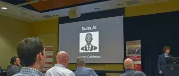 Suits.AI on screen during Goldman's pitch