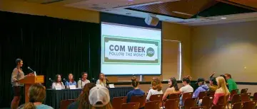 Com Week 2024 graphic on screen