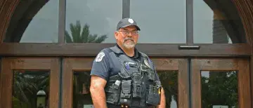 Officer Gary Johnson in front of Proctor