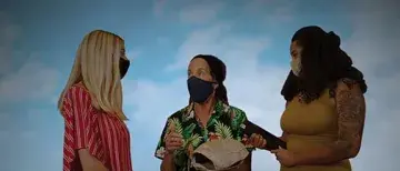 Three women are talking together.