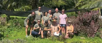 Matthew Murasko poses with a group in Hawaii
