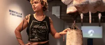 Ceam Artist in gallery with artwork