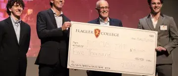 FocusTap student founders Jesse Van Krimpen and Reiss Skeen accept cash prize at Lion's Cage competition