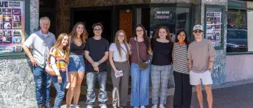 A group of students pose for a photo following a day of ad agency tours