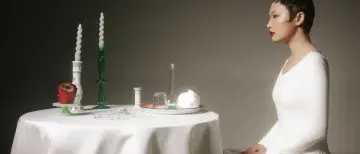 Juried Art Exhibit - Woman sitting at a table