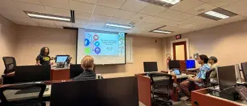 Student Jazmine Major presents to her class in St Augustine, and virtually in China