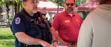 Officer Gary Johnson directs a student by pointing to a map