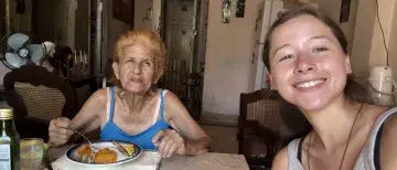 Sophia Cardona sits with an elderly Cuban woman