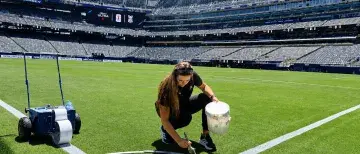 Brooke Rienecker painting the corner of a soccer field for the FIFA World Cup