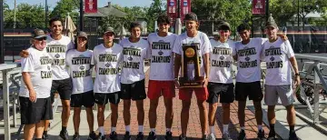Men's Tennis Team posing together with the championship trophy