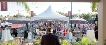 Wide shot of the dedication ceremony at the tennis courts