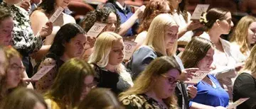 Students reading core value pledge at Baccalaureate 2022