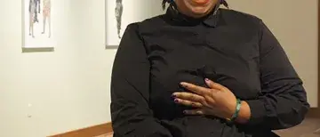 seated photograph of Florine Démosthène smiling in CEAM