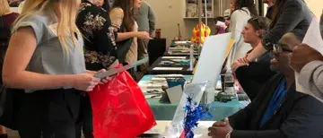 Student talking with employer at spring career expo