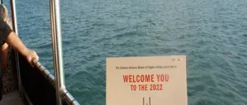 i-Tz9MD69-X3 505x505.jpg Someone is holding the Sunset Cruise invitation with water and a lighthouse in the background