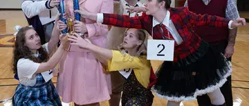 The cast of "The 25th Annual Putnam County Spelling Bee" poses together in the Flagler College Gymnasium