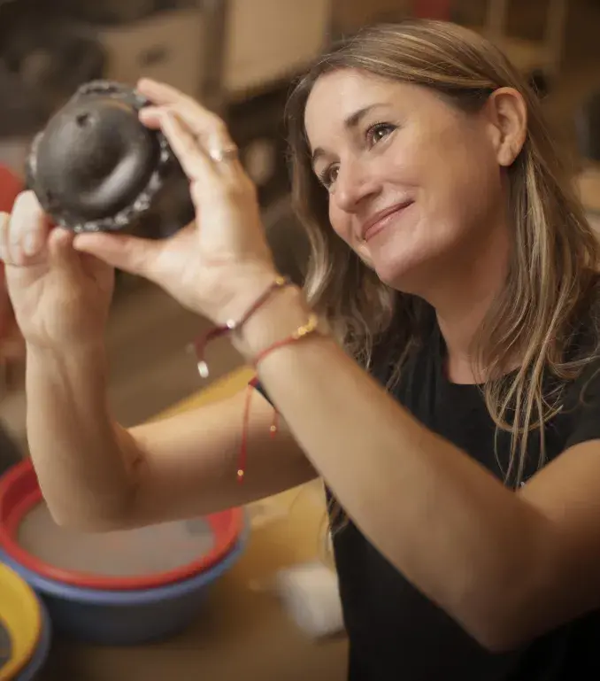 A Flagler College archaeology student examines a piece of pottery.