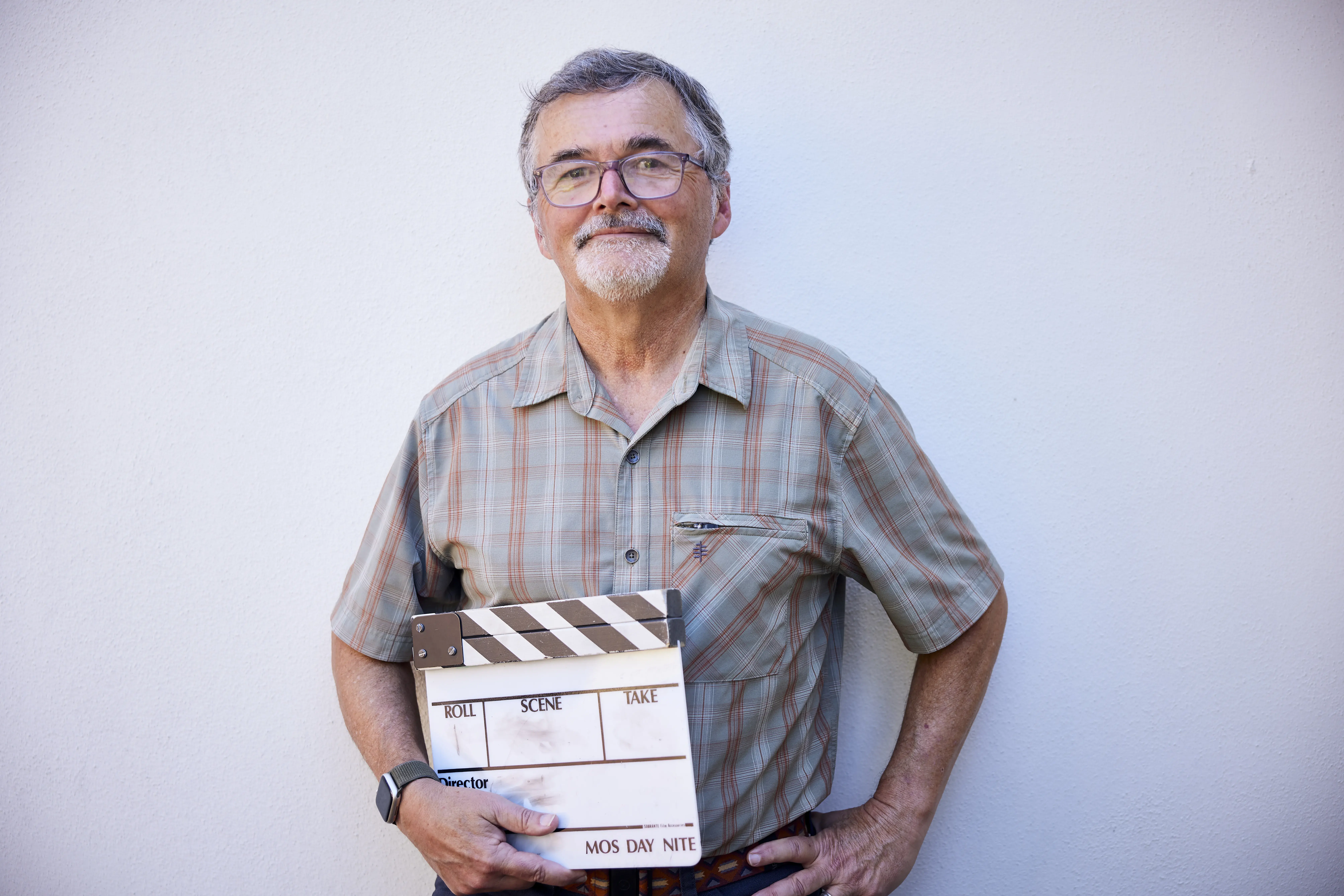 Jim Gilmore holding a clapperboard