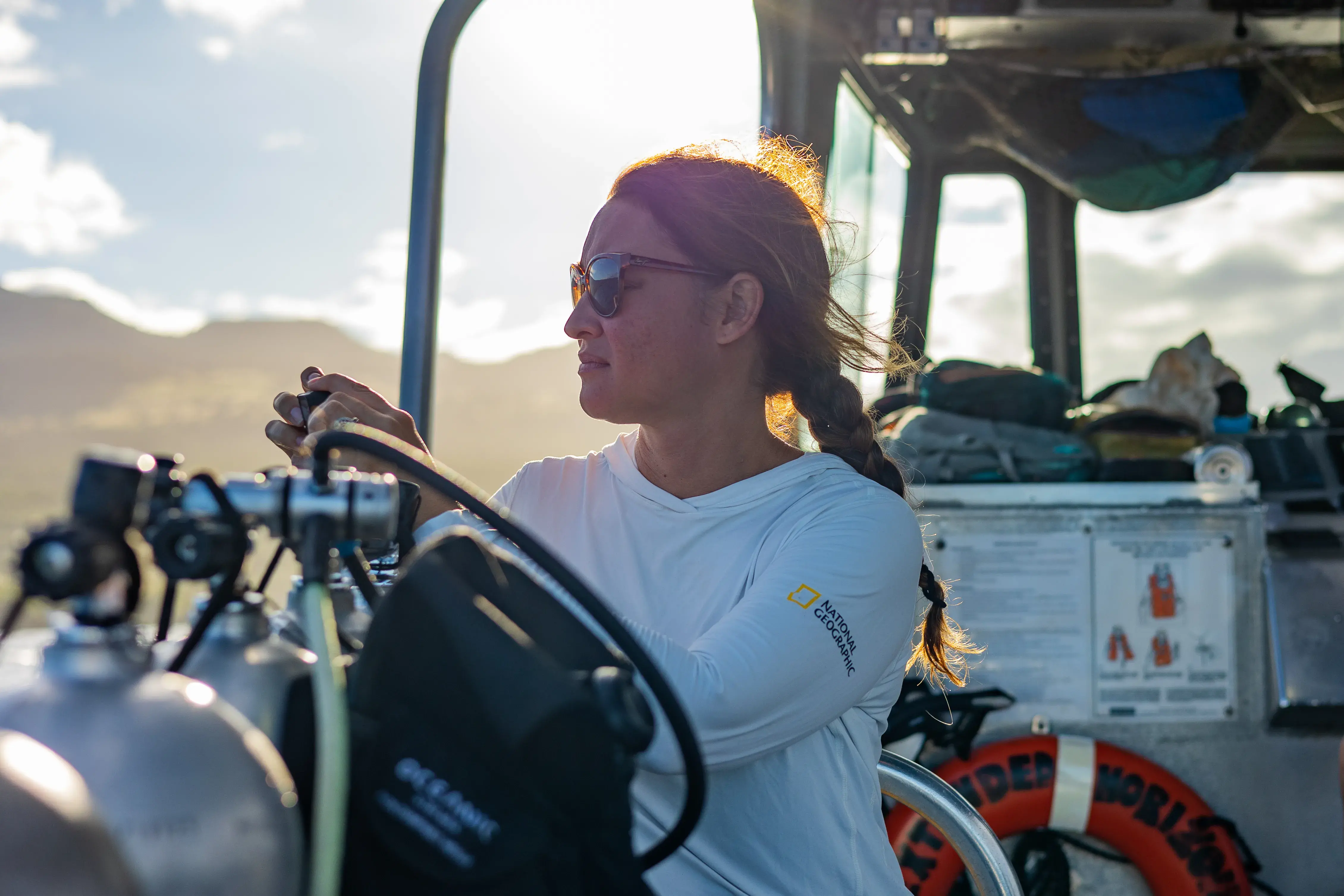 Ashley Glickley at the wheel of a boat 