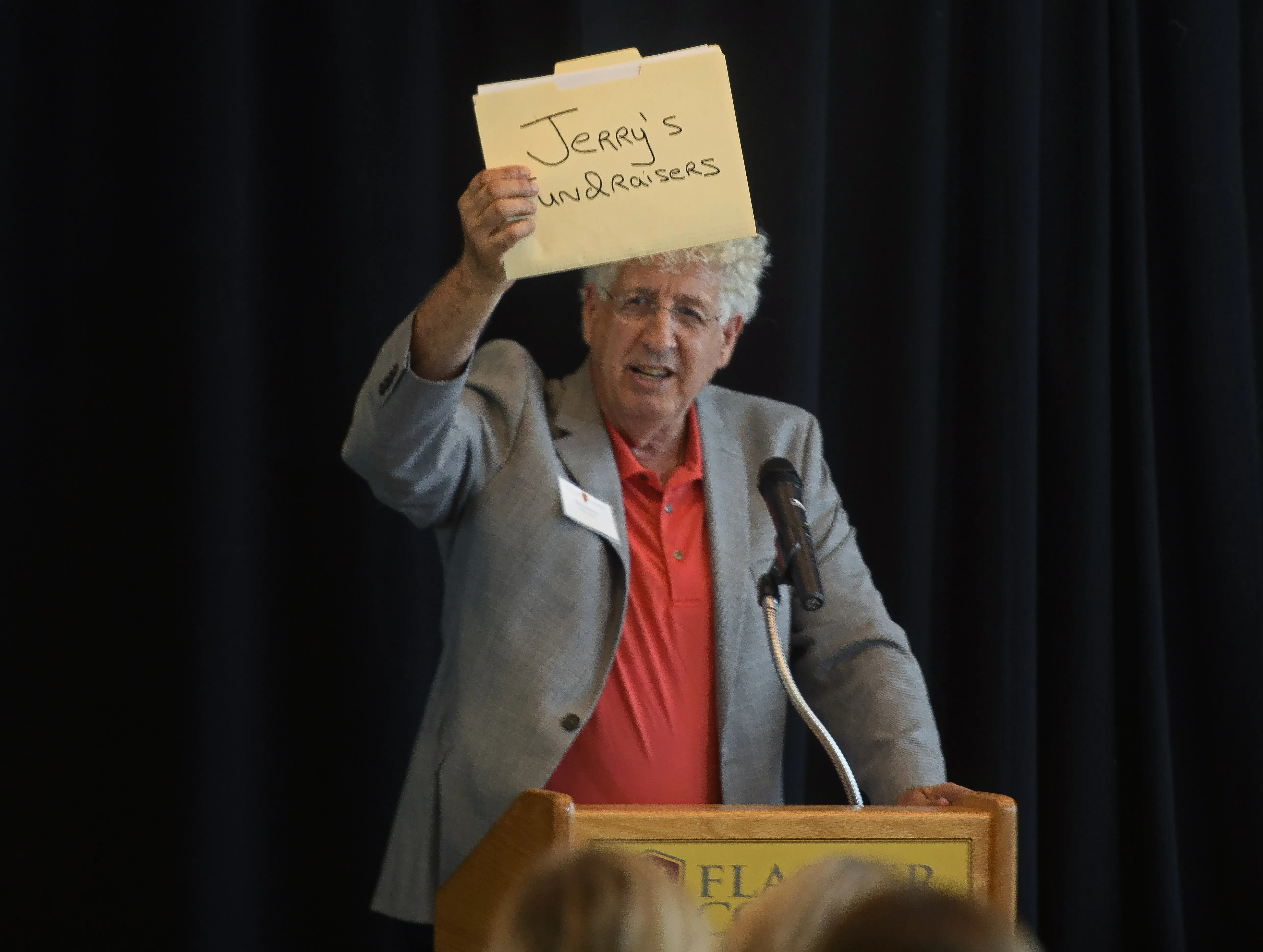 Ron Summers holding folder that reads, "Jerry's Fundraisers"