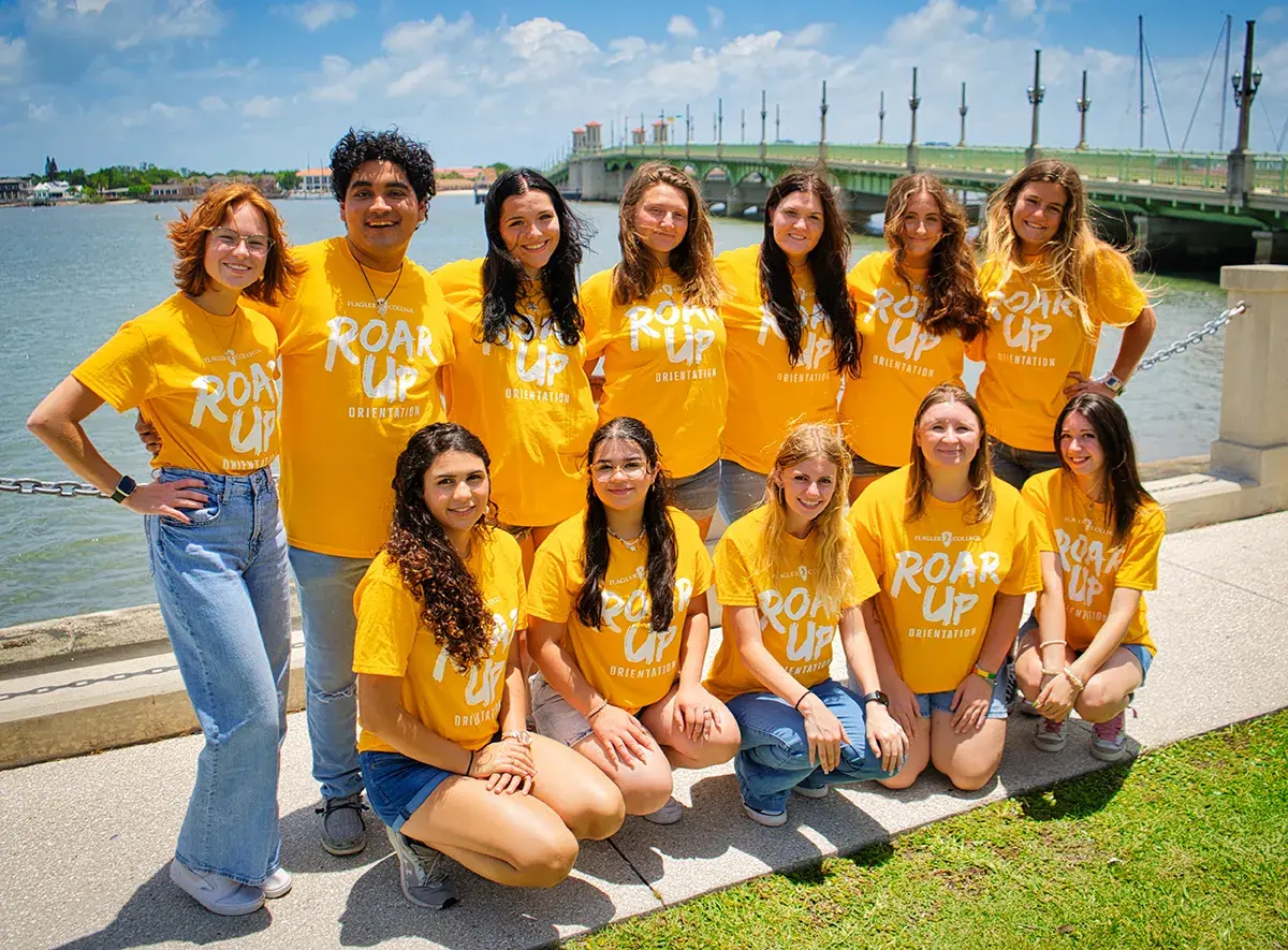 Group photo of all of the Orientation Leaders with the Bridge of Lions in the background