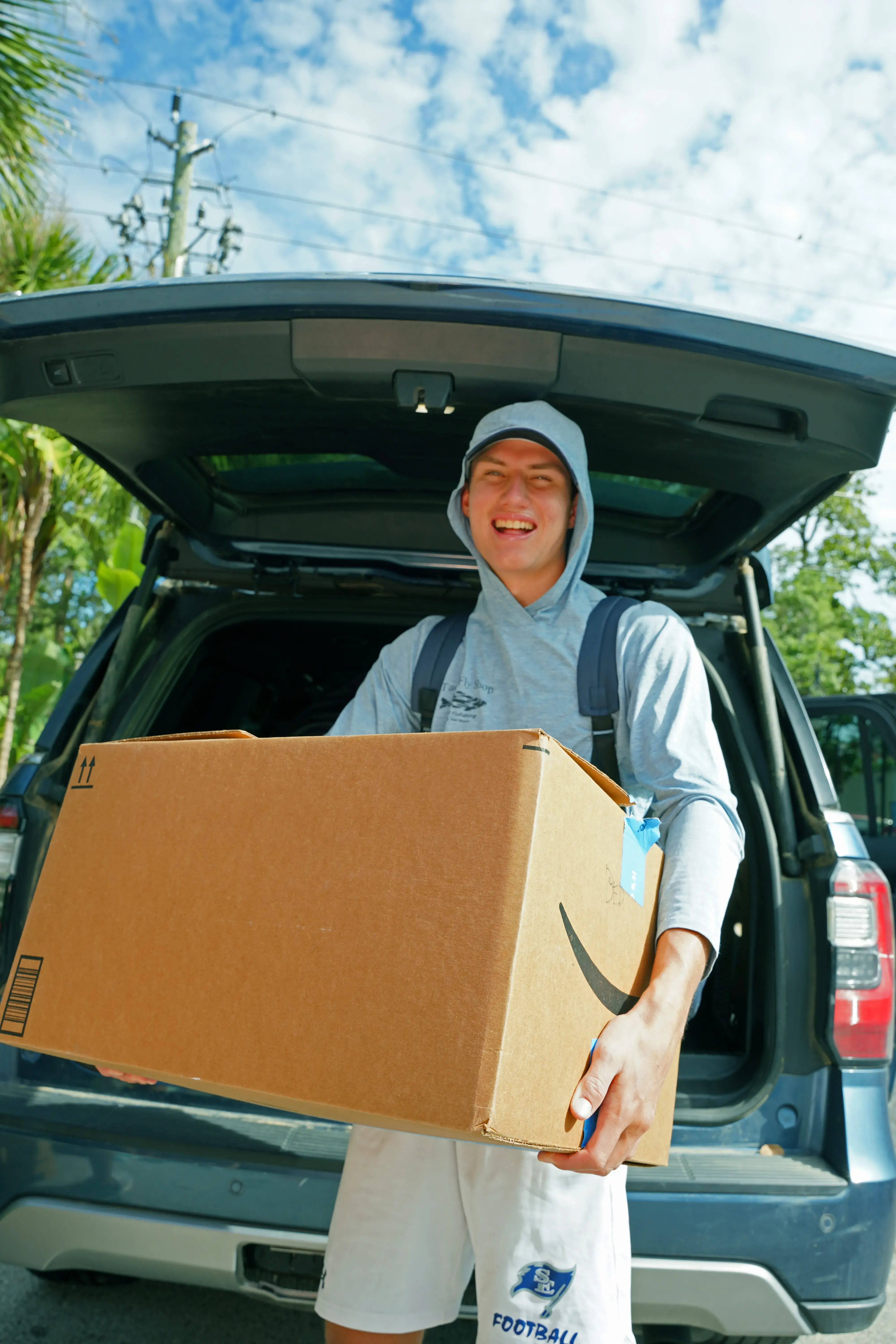 Student holding box outside