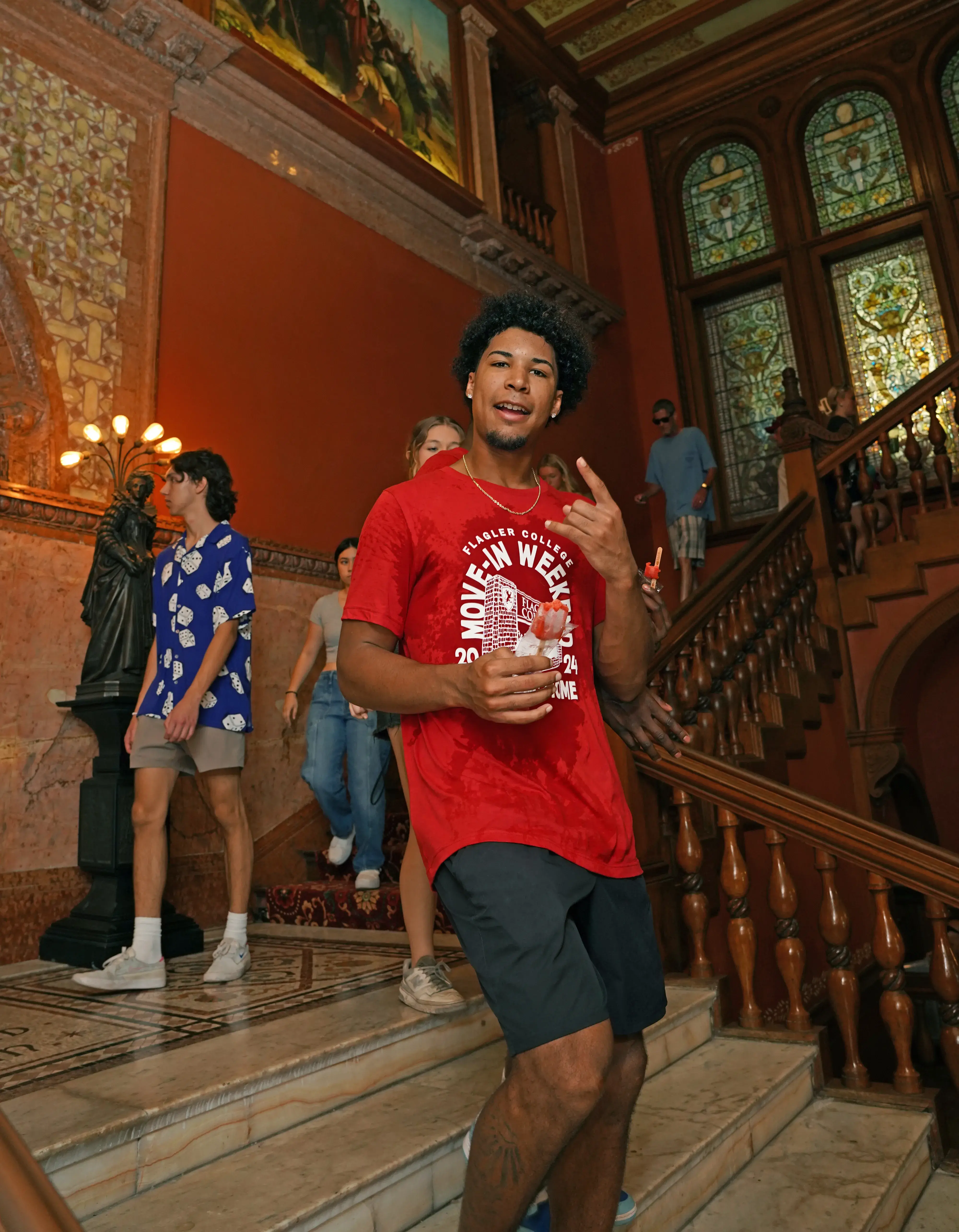 Student athlete on Move-In Day with stained glass behind him