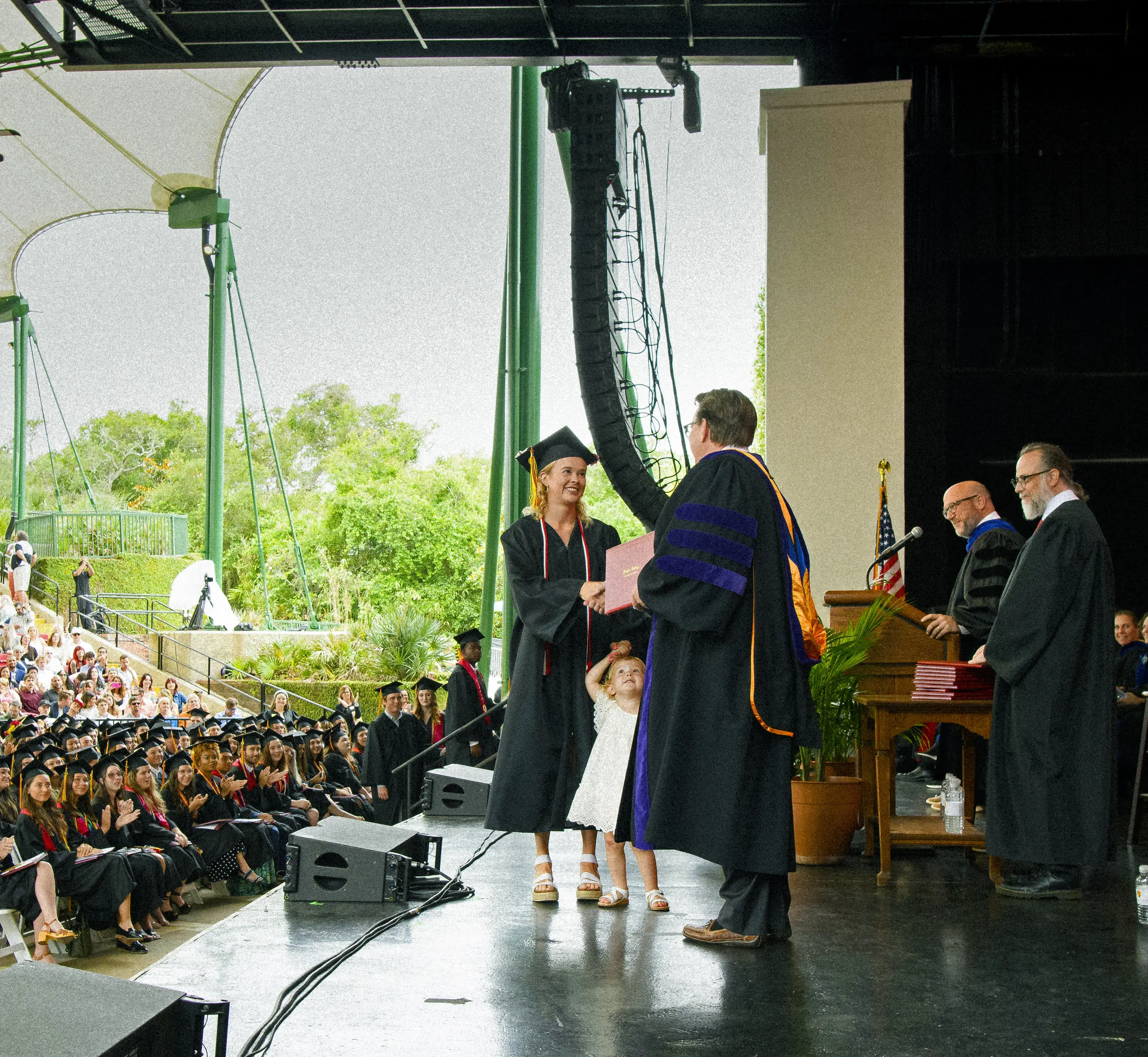 Madison Hope Taylor ('23) and daughter crossing stage at Commencement