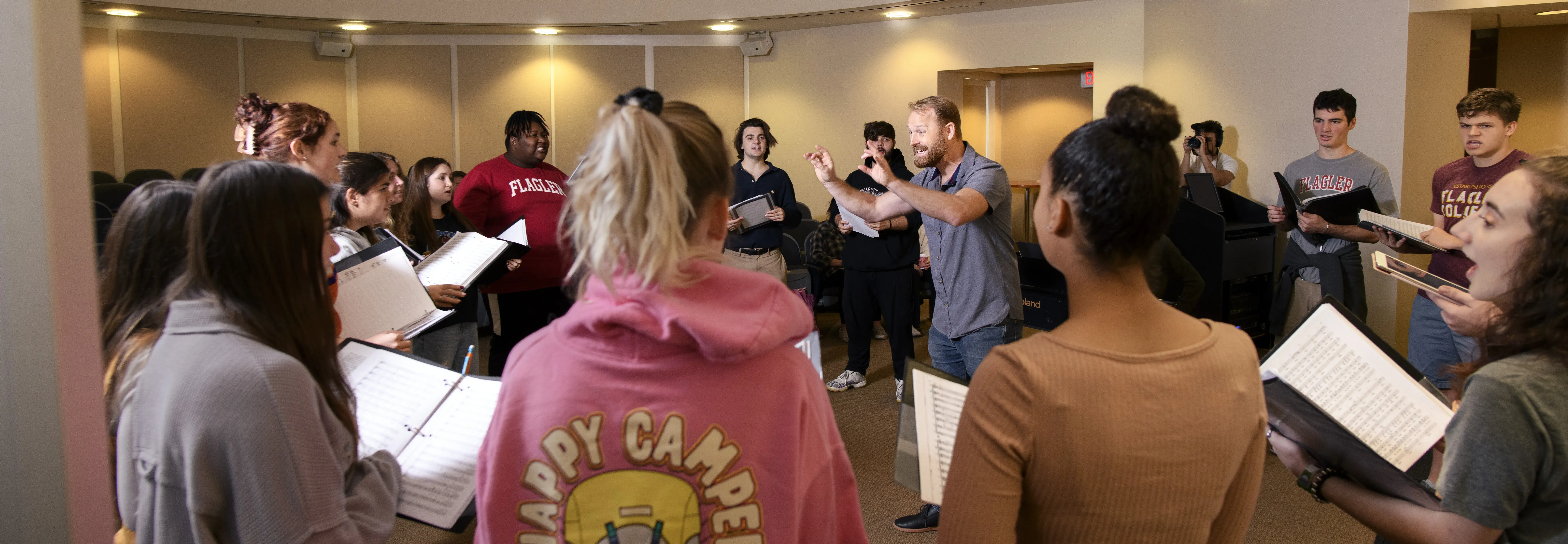 Panoramic shot of Professor Taisey directing an ensemble in rehearsal