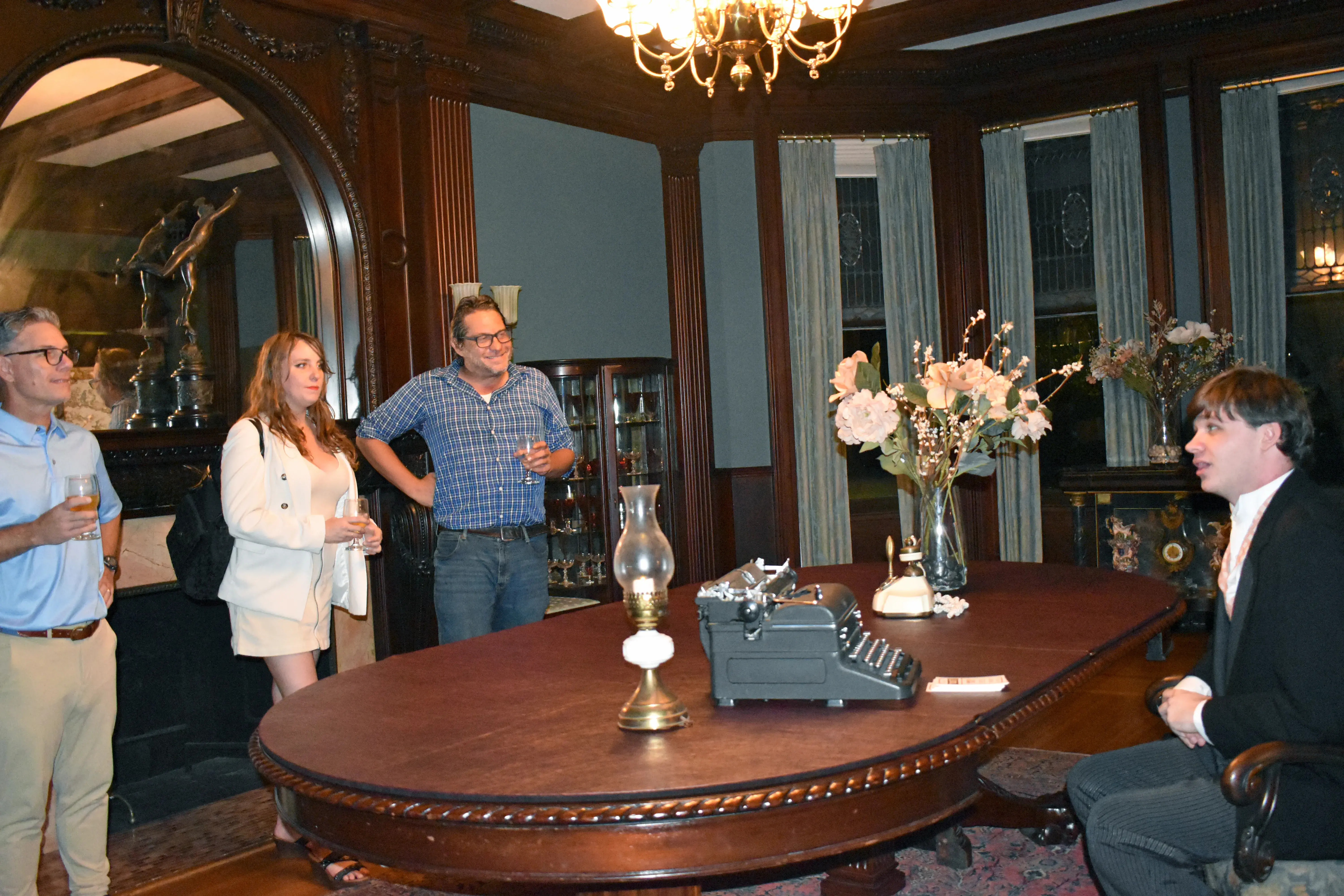 Henry Flagler's character sitting at dining room table while delivering monologue to guests