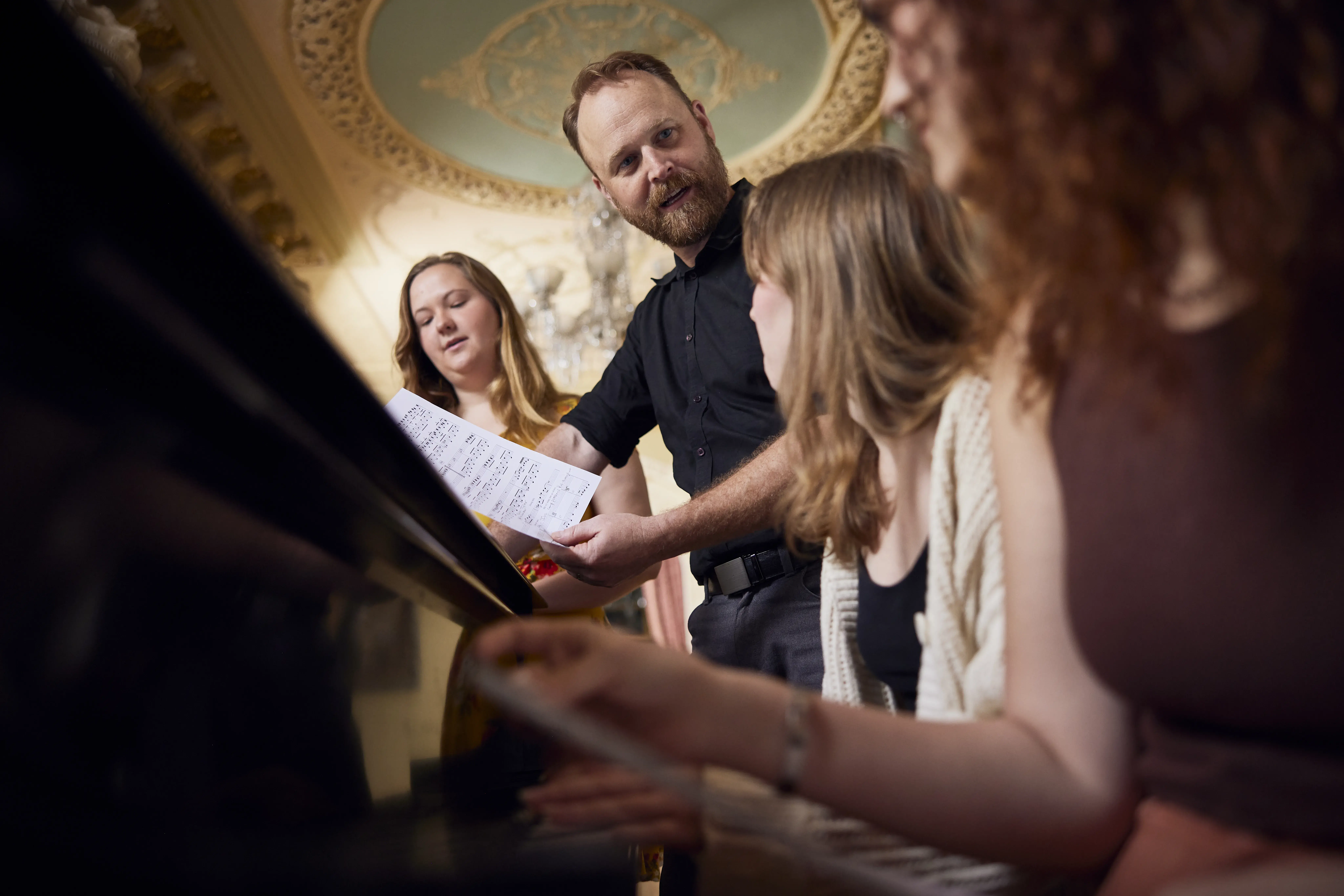 Taisey & students in the Flagler Room at the piano