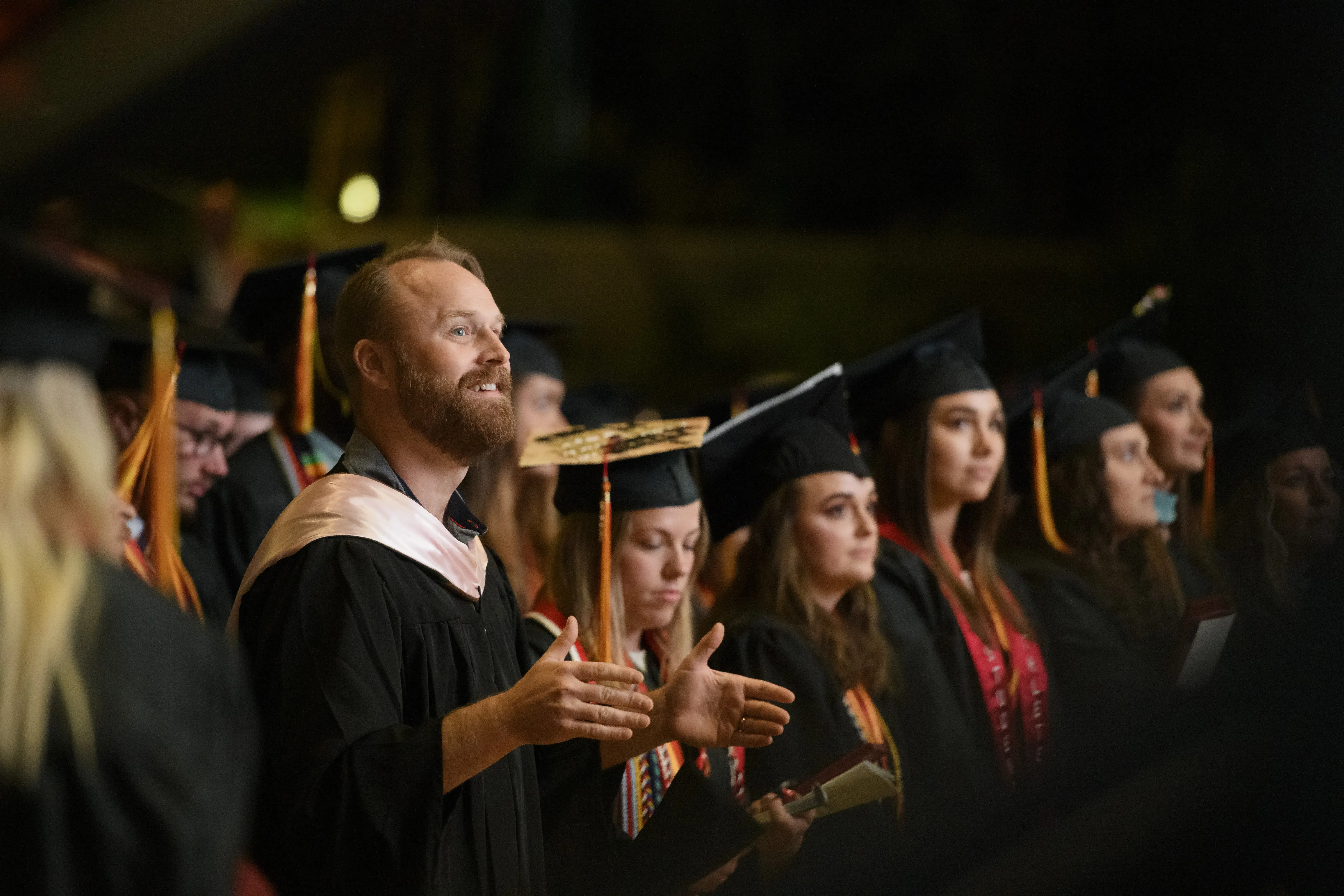 Taisey directing an ensemble during Commencement
