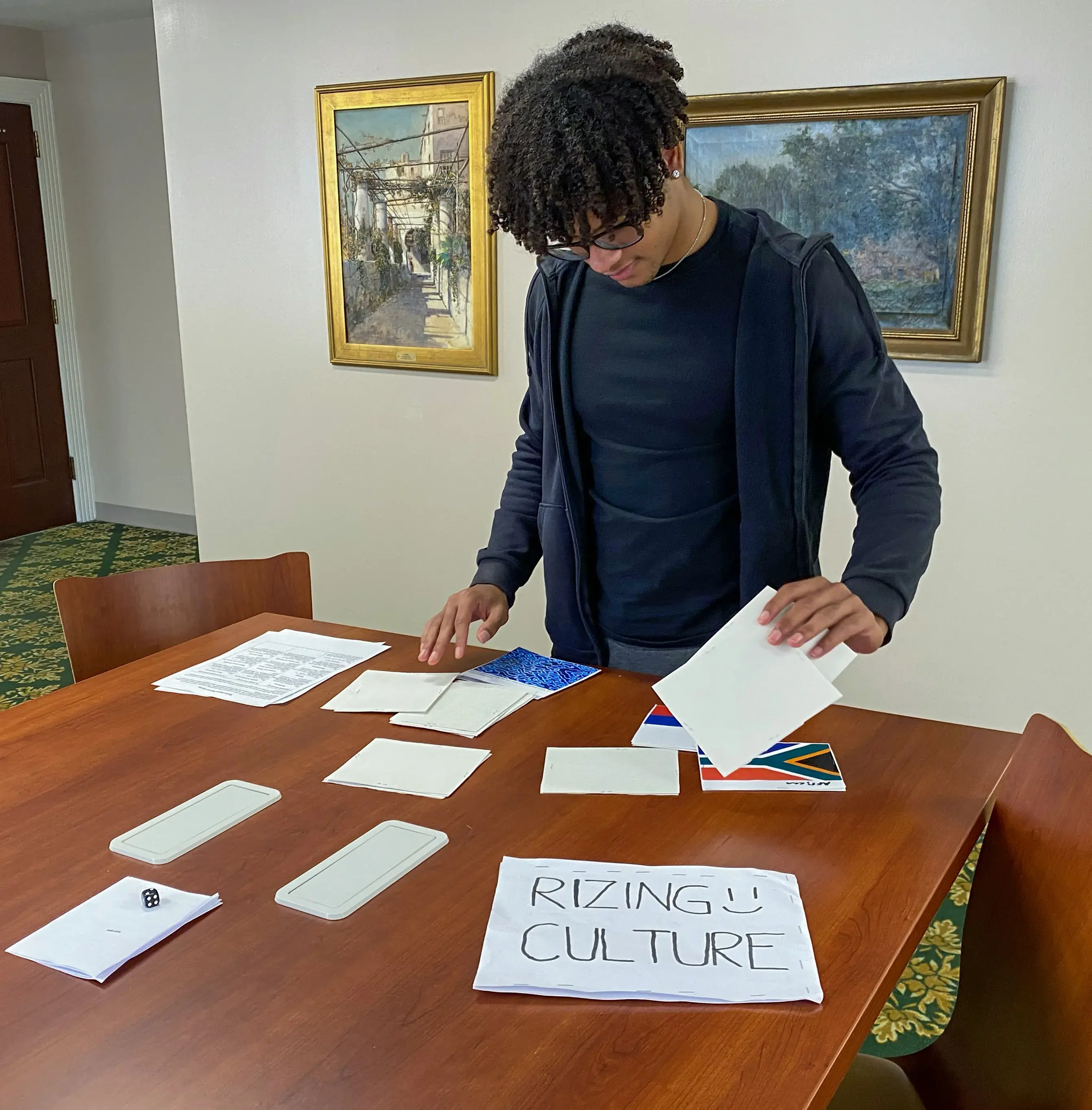 Single student playing matching card game titled "Rizing Culture"