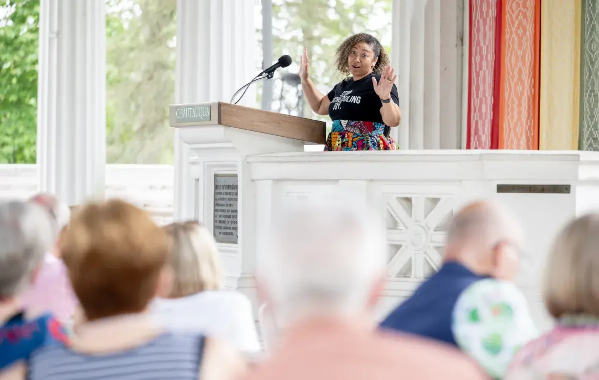 Dr. Lakisha Lockhart standing at a podium talking to a crowd.