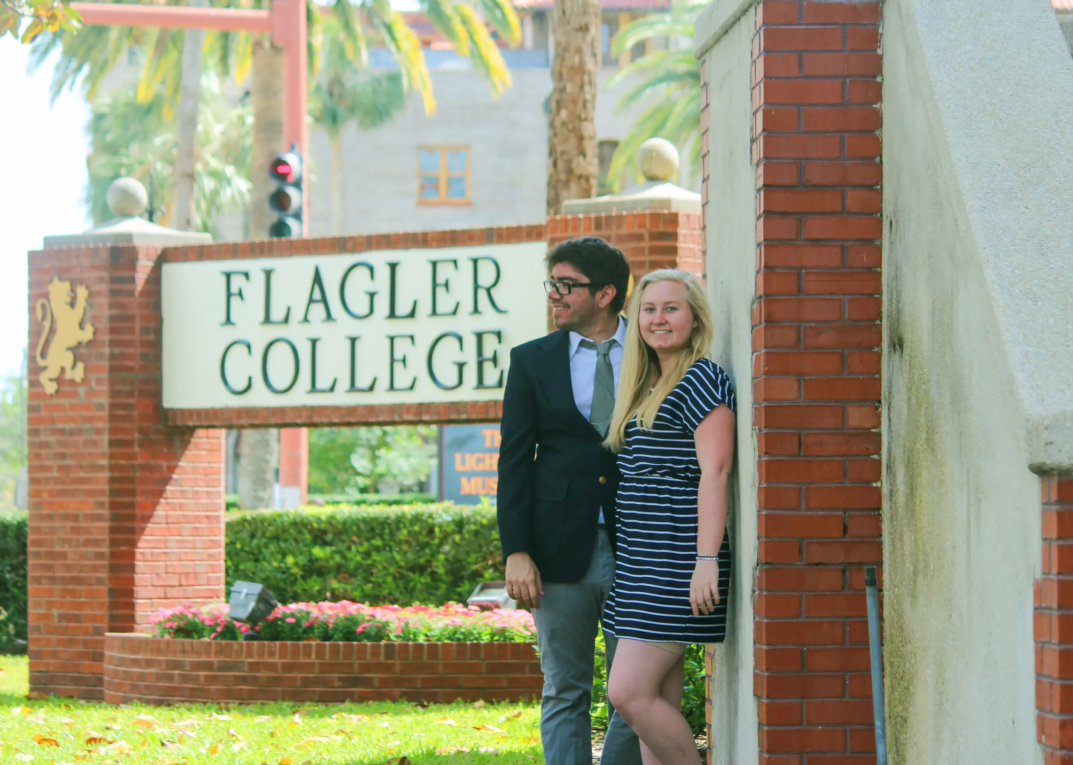 Meet-cute feature hero image (Taylor & Josh posing in front of Flagler sign)