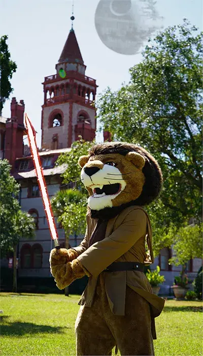 Lewis the Lion is holding a lightsaber. The Ponce towers are in the background, with the Death Star hanging in the sky like a moon.