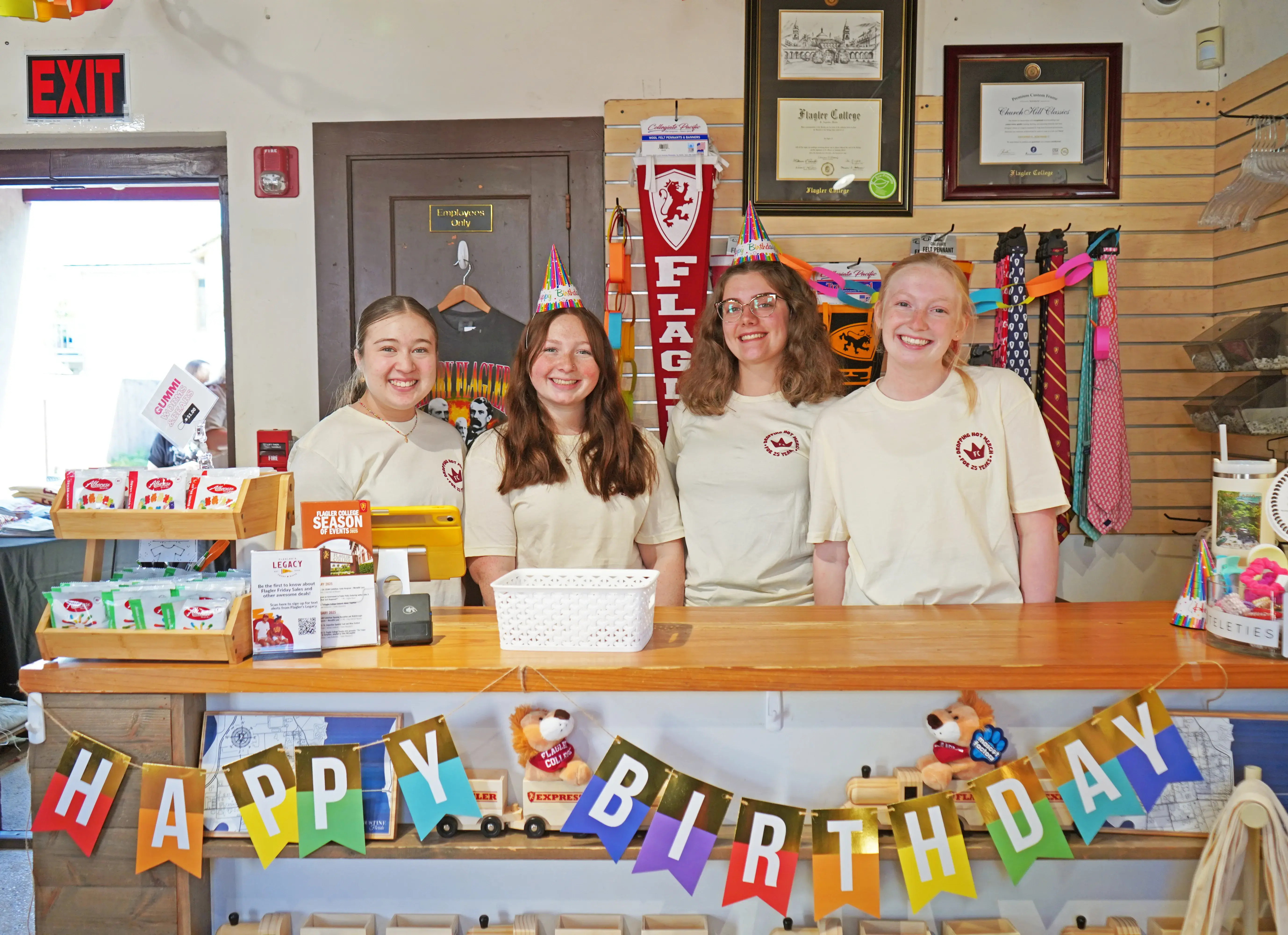 Student worker's posing behind Legacy counter at B-day celebration